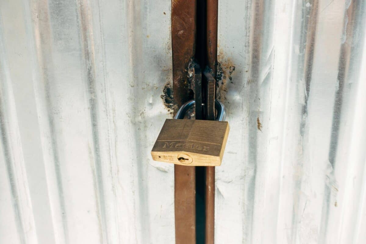 Secure padlock on metal door emphasizing privacy and security.