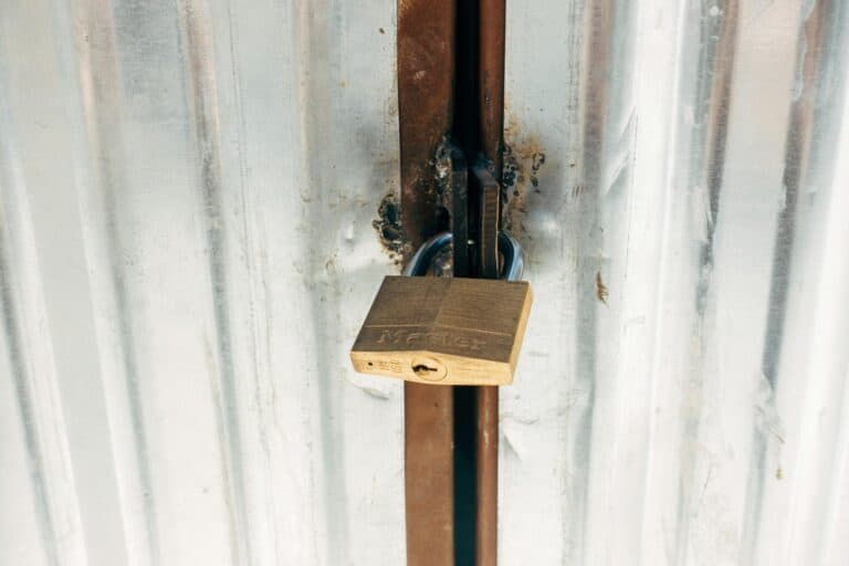 Secure padlock on metal door emphasizing privacy and security.