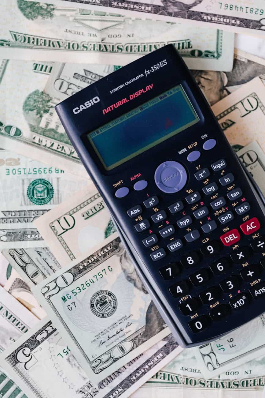 Calculator on cash with dollar bills, illustrating website pricing in Edmonton.