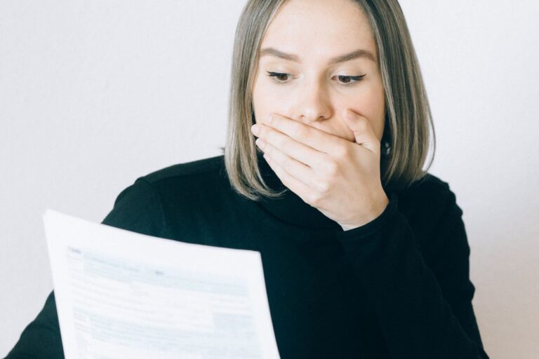 Business owner shocked reading an unexpected hosting invoice - bot traffic bandwidth charges